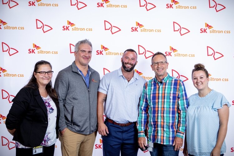 Eric Moore, center, is one of hundreds of people working at SK Siltron CSS facilities in Bay County. From left are employees Victoria DeRuiter, Brandon Bedtelyon, Moore, Steve Sherlock and Tanner DuFresne. (Photo courtesy of SK SIltron CSS)