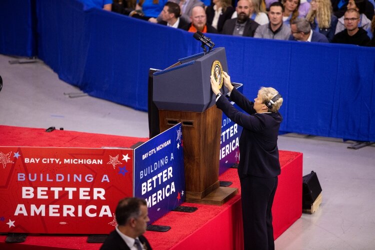 Event staff attached the Presidential Seal to the podium just before President Biden came on stage. 