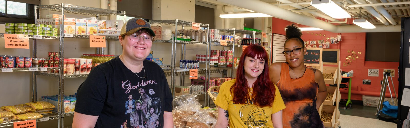 EMU students Ren Lands, Lauren Masserant, and Ruth Mella work at Swoop's Food Pantry.