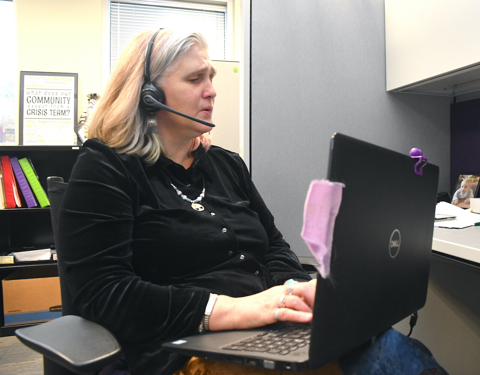 Valerie Lamper, on the phone, is a clinical social worker at Summit Pointe’s First Step Urgent Care.