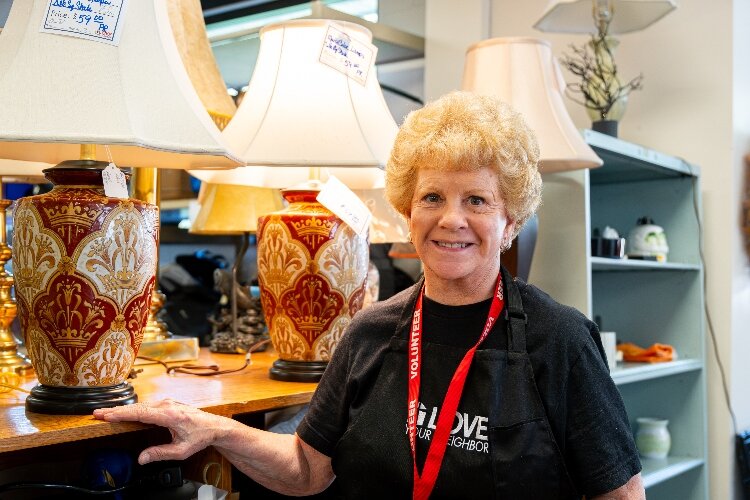 Volunteer Polly Agers oversees lamps and lighting at the store.