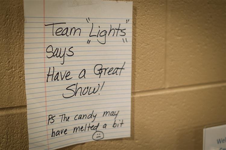 A good luck note from the lighting and production team hangs backstage.