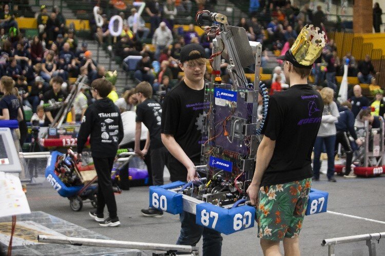 A robot is carried off the course during the FIRST.