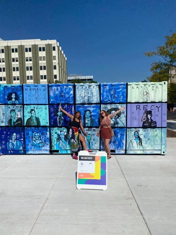  Maya James and her friend unveiling the mural that Maya was commissioned to create on a storage container for Artprize 2021. 