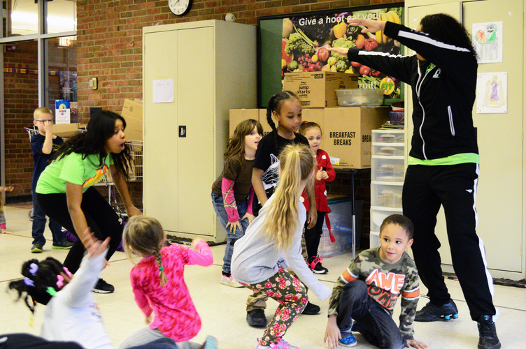 Emirrora Austin helps LaMora kindergarteners ”shake their sillies out.” Photo by Mark Wedel