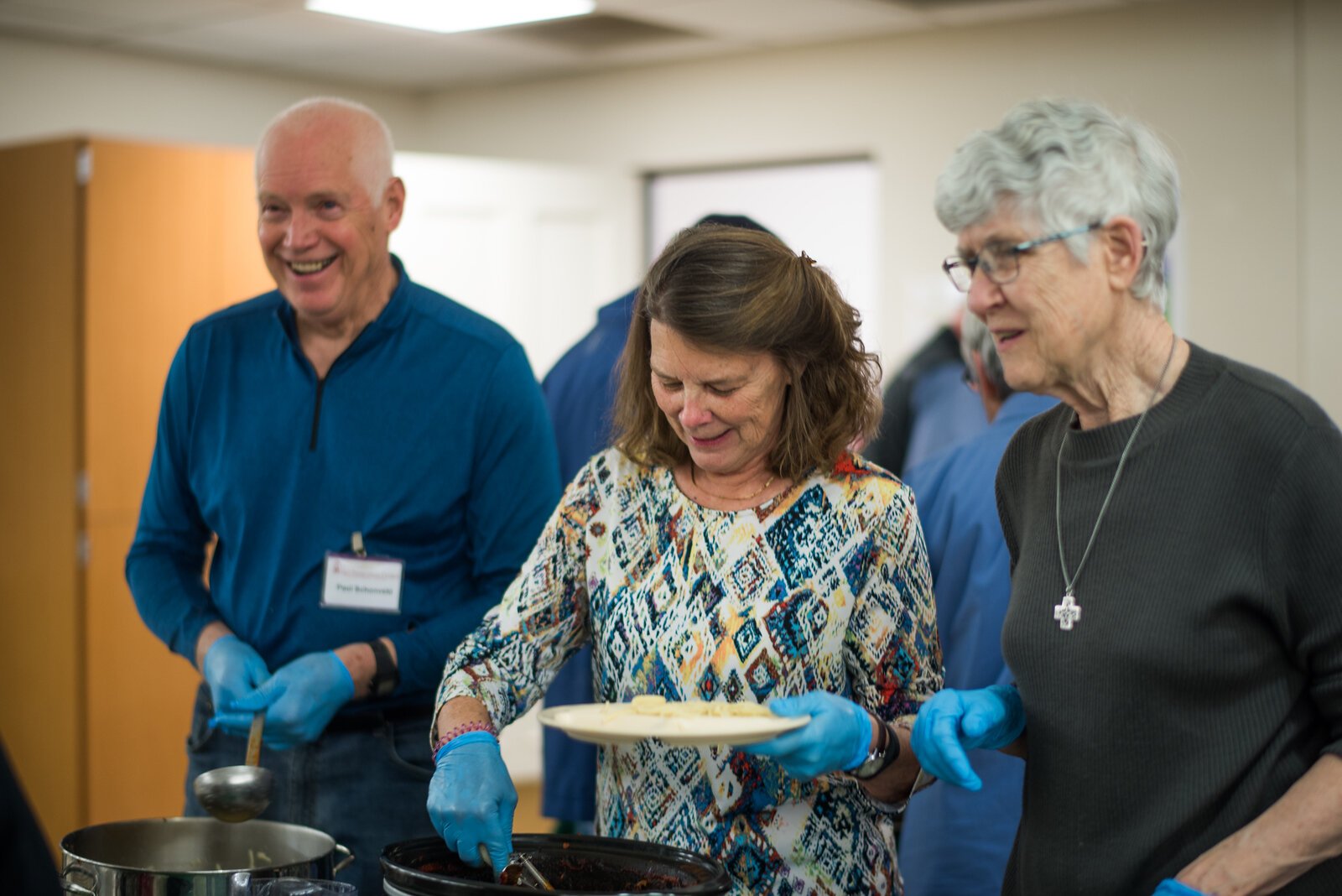 Church volunteers greet and feed diners at First Presbyterian's weekly Red Door dinners.