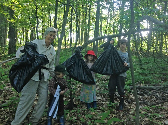Youngsters pull garlic mustard at a Southwest Michigan Land Conservancy Preserve.
