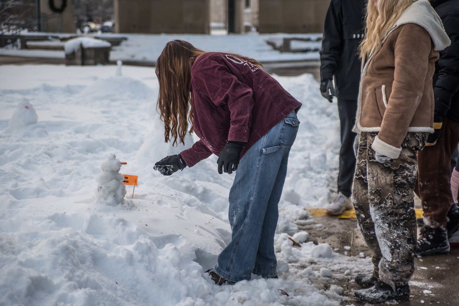 Students built mini snowpeople throughout Bronson Park and on the steps of City Hall.