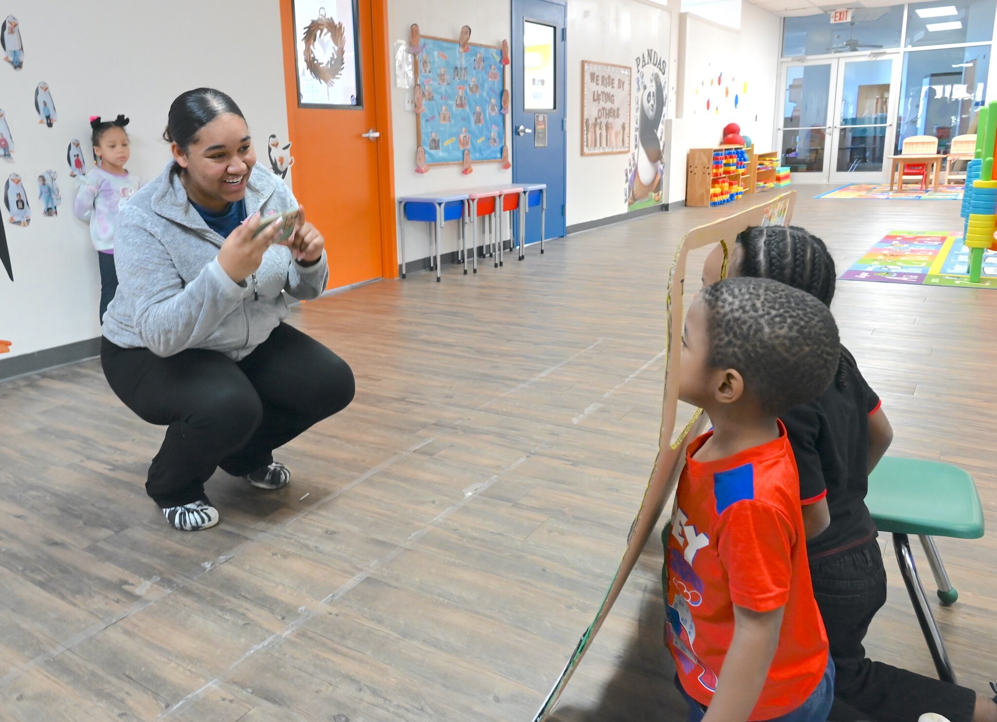 Naziah Feaster takes a photo of young children at New Harvest Christian’s Learning Center.