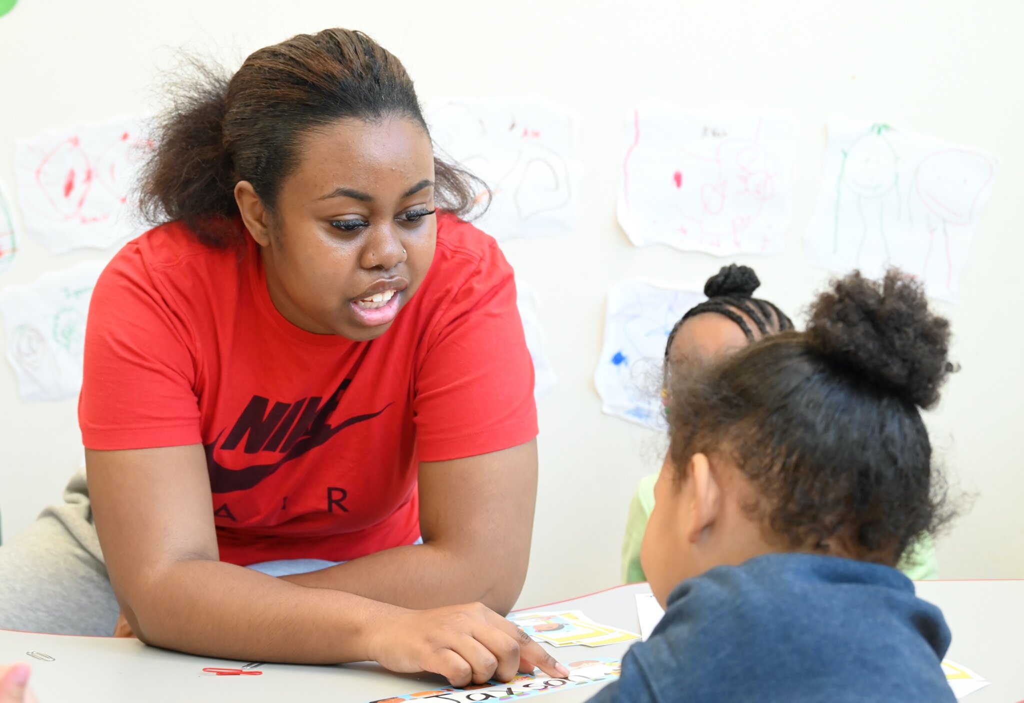 Ivanna Lee works with a young child at New Harvest Christian’s Learning Center.