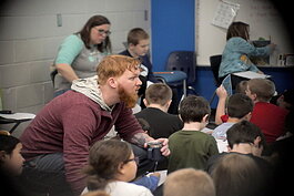 Dillon Barr works with students in a classroom, teaching them about how to find to find their path.