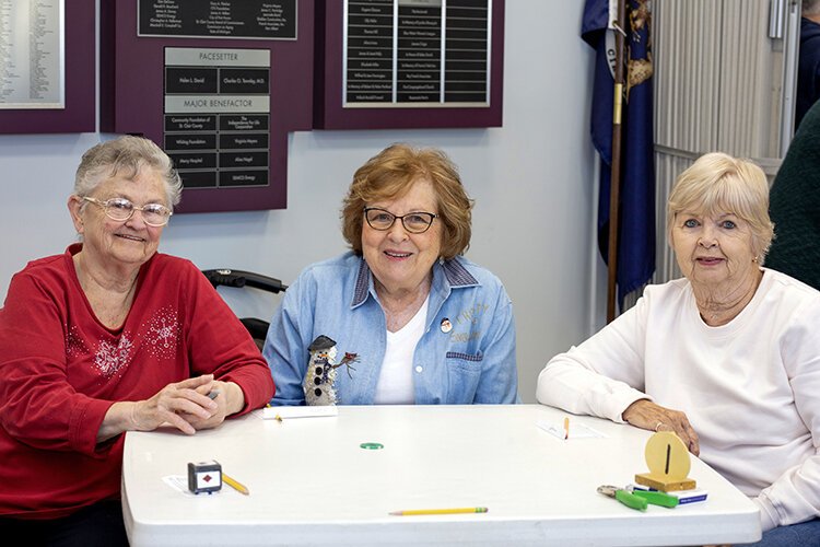 (From left) Mary, Karen, and Joanne pose for a photo together after playing a round of euchre at the St. Clair County Council on Aging in Port Huron.