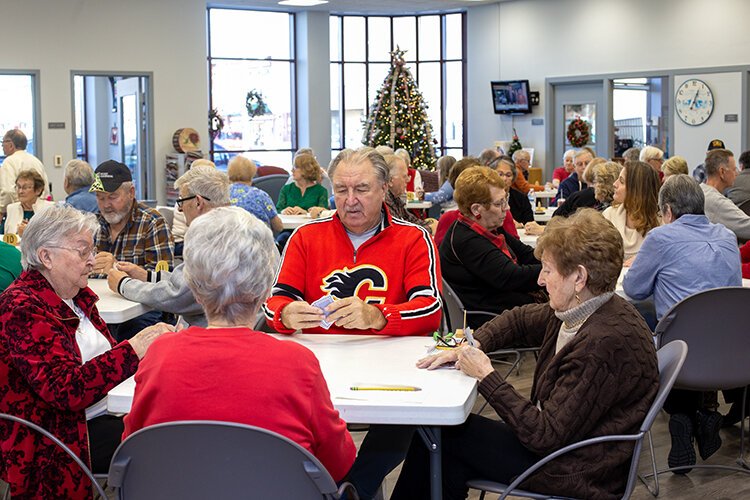 A large group gathers together to play euchre at the St. Clair County Council of Aging in downtown Port Huron.