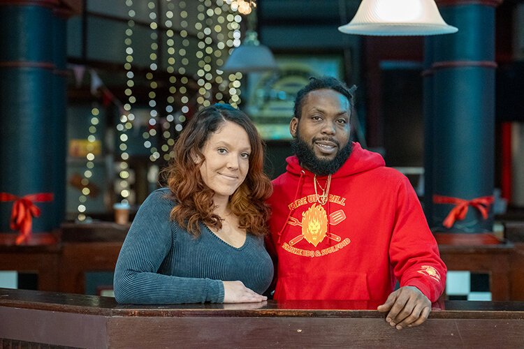 Owner Jalen Hayes Sr. poses for a photo outside Fire Up Grill beside his partner and co-owner Ashley Robertson.