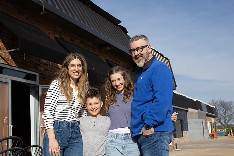 Nicole and Rob Fowler, the owners of Fowler's Creamery & Coffee, stand outside their storefront in downtown St. Clair with their children Nash (left) and Harper.