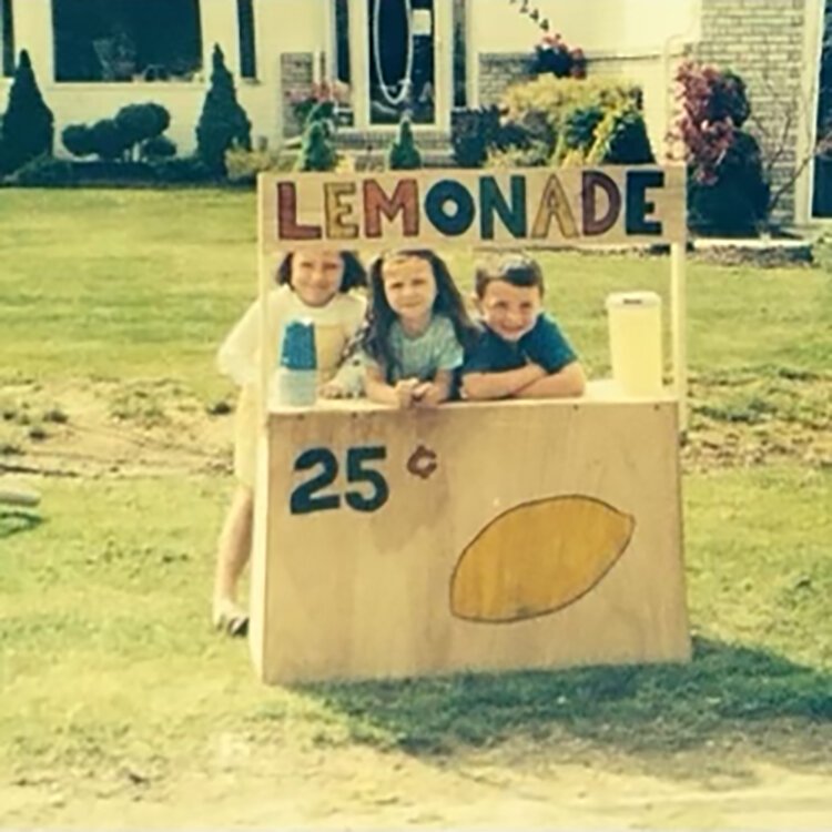Childhood photo of Jacob Skarbek helping attend a lemonade stand.