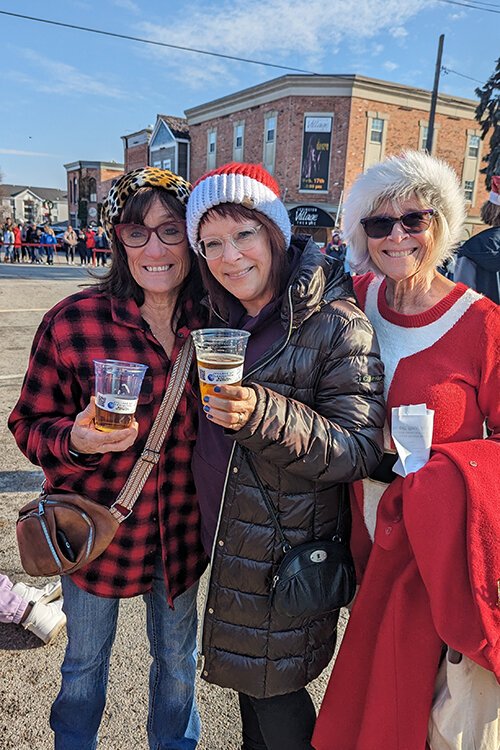 (From left) Dina Reckinger Wurmlinger, Mary Jo McGovern, and Kathy DeCoster pose for a photo during Lexington's Christmas Horse Parade.