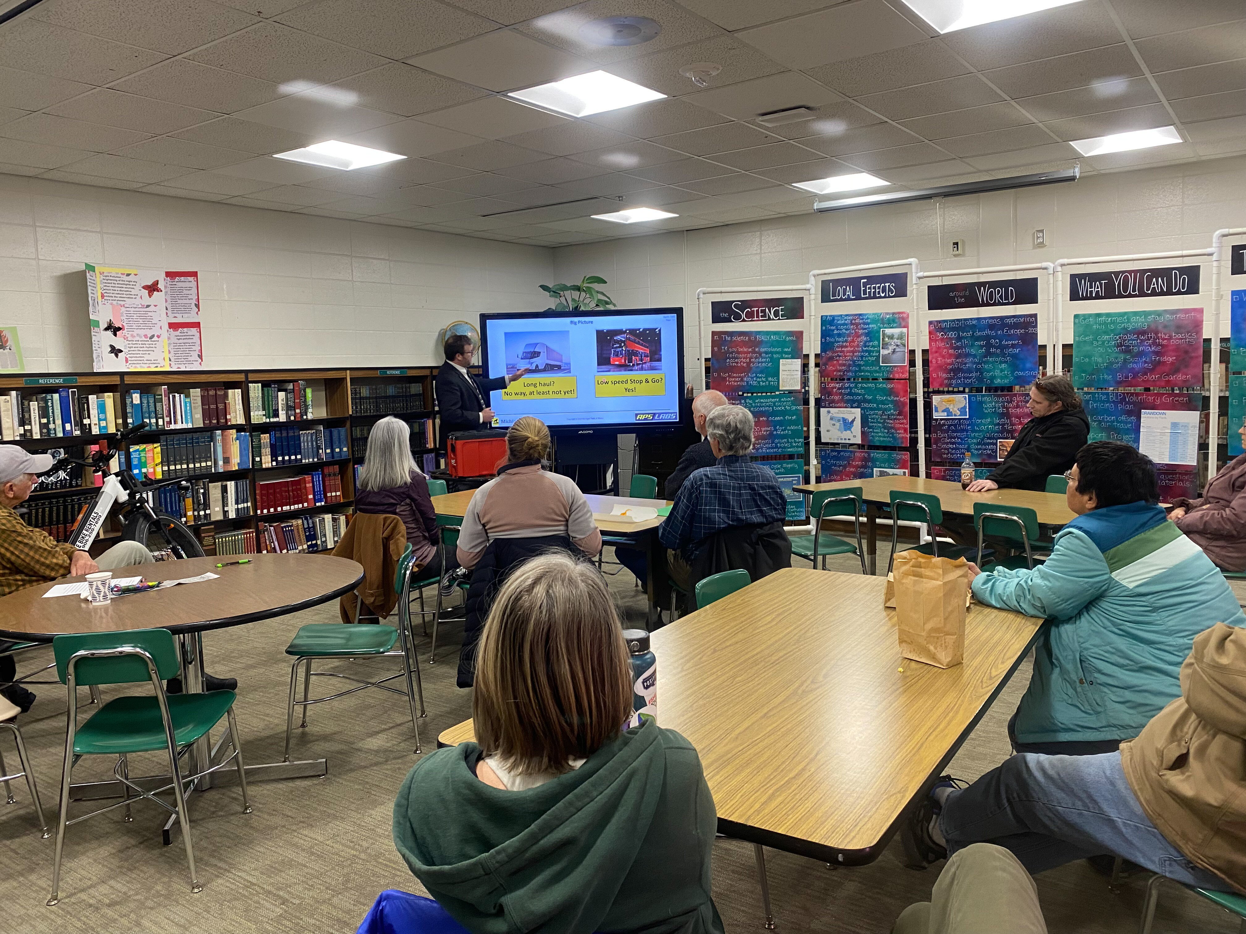An engineer from Michigan Technological University presents on electric vehicles at the Munising School Public Library as part of Earth Fest. 