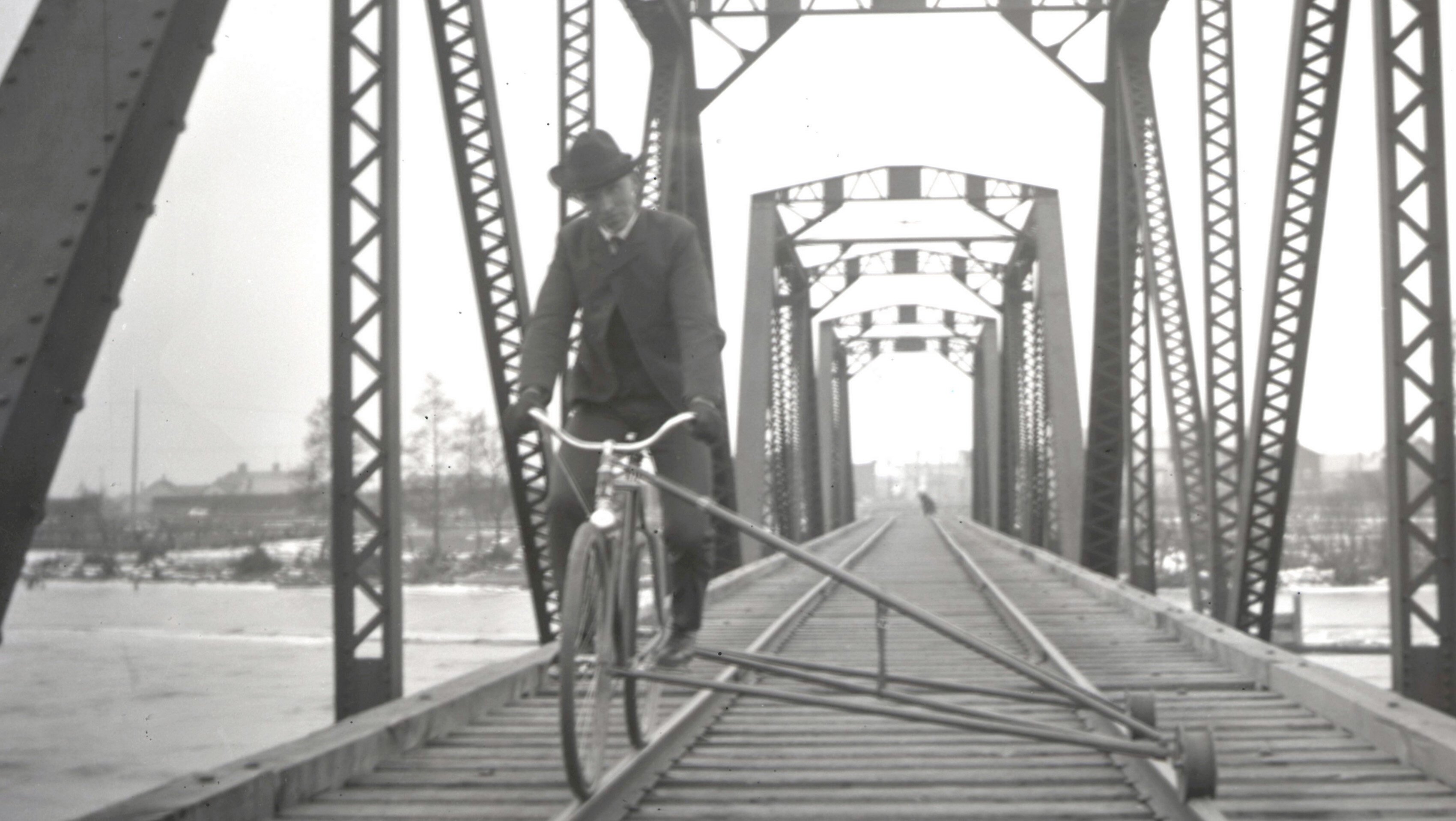 An unidentified man rides a railroad bicycle in Manistique.