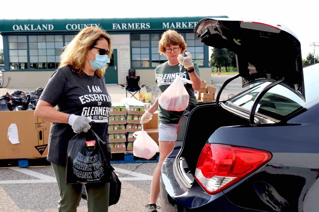 Volunteers for Gleaners Community Food Bank at the Oakland County Farmers Market mobile distribution