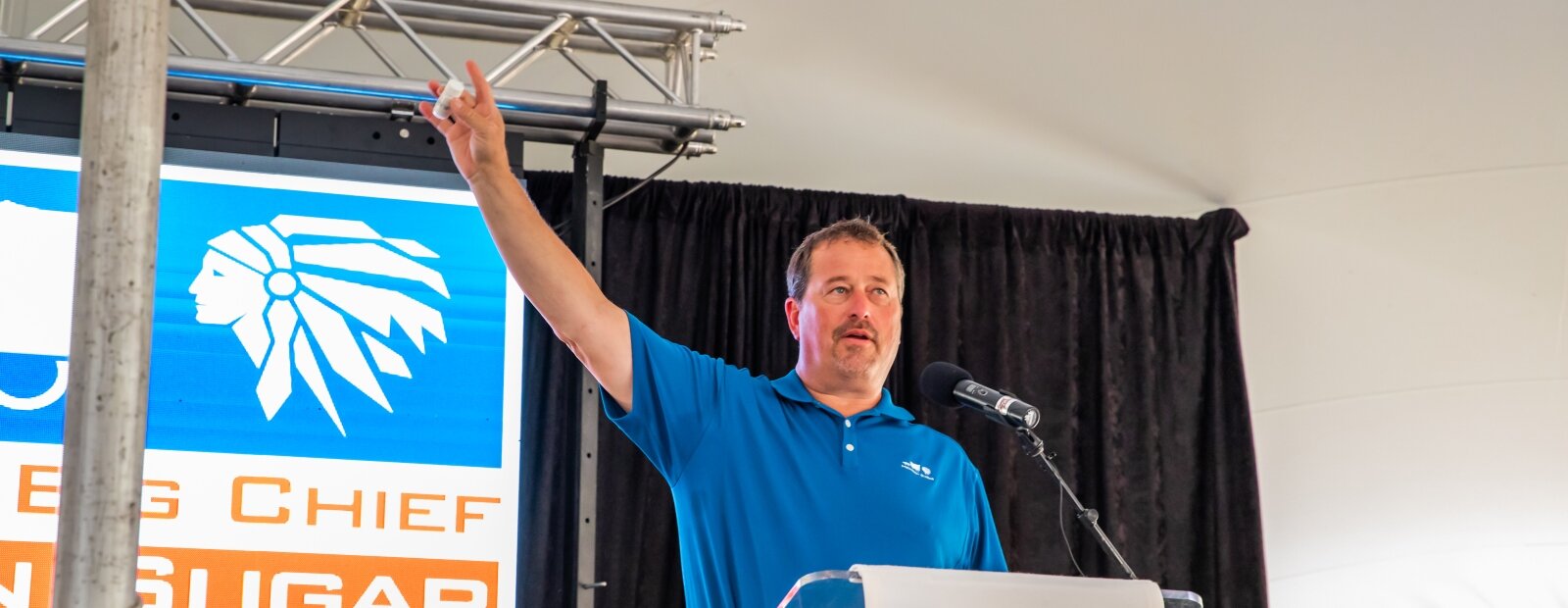 Michigan Sugar President & CEO Neil Juhnke holds up a tube of sugar extracted from molasses at the Bay City plant.