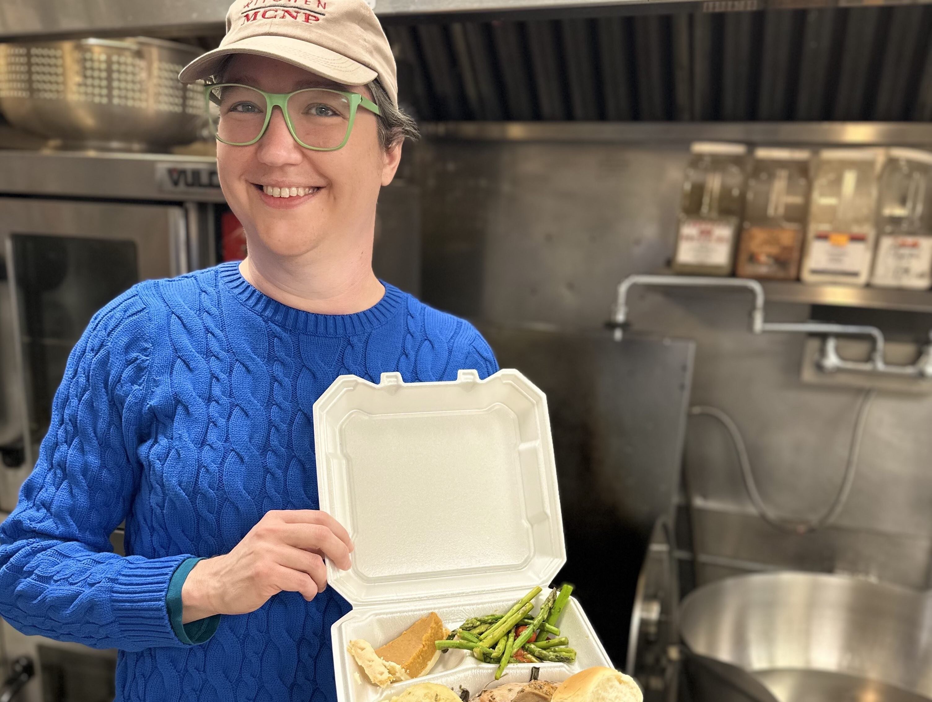 Sarah Jones with a to-go meal from Mid City Nutrition 