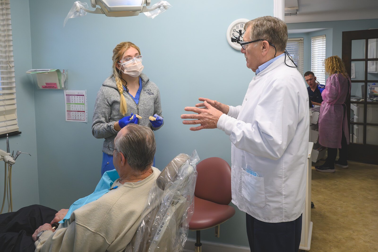 Dental intern Rylee Miller, patient Louie Hampton, and Dr. Howard Hamerink at the VINA Community Dental Clinic in Brighton.