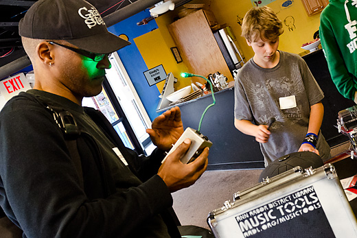 Alvin Hill and Zane Pelletier checking out Music Tools from the Ann Arbor Library