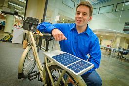 Ansgar Strother with an A2B Bikeshare bicycle at the TechArb