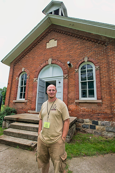 Dixboro Farmers' Market manager Jason Gold in front of the school house