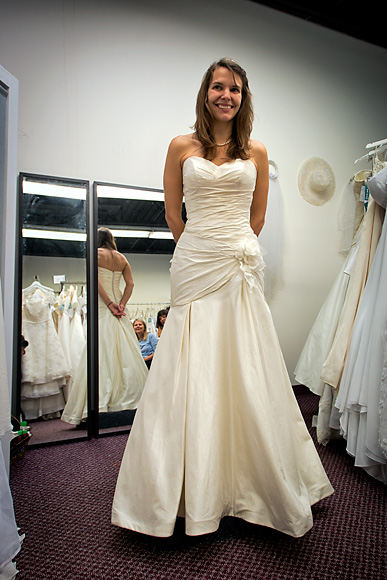 Kristen Oltersdorf trying on a dress at The Brides Project Boutique