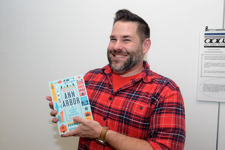 Richard Retyi with his book The Book of Ann Arbor: An Extremely Serious History Book