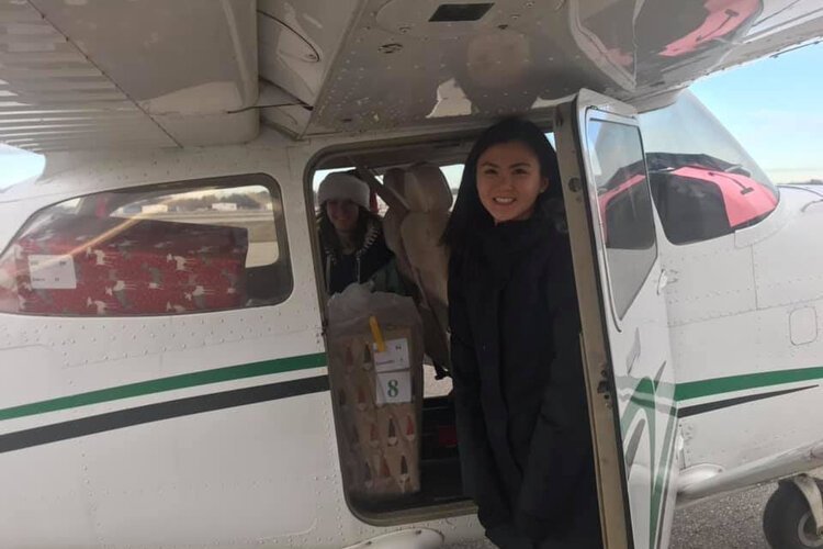 Volunteers load a plane with presents.