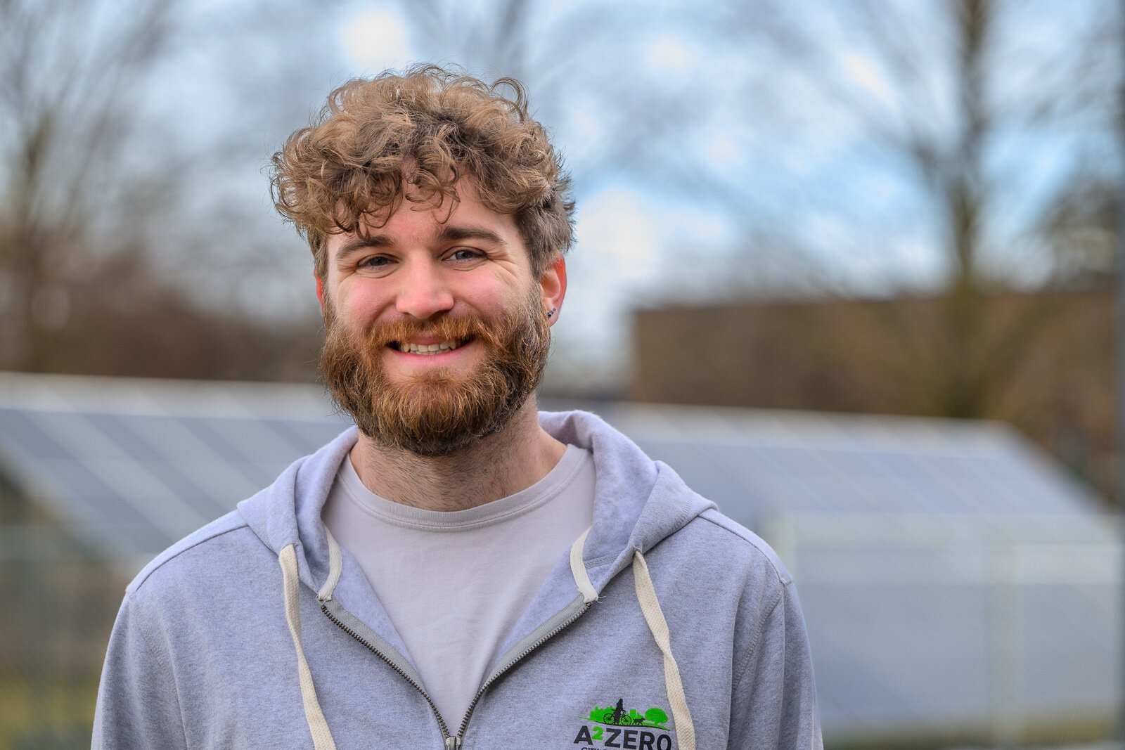 Joe Lange by solar panels at Northside Community Center in Ann Arbor.