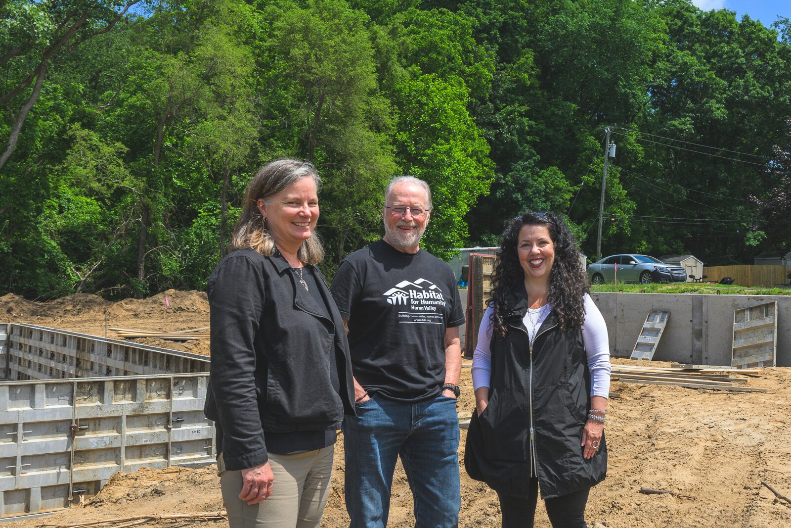 Jeanette Jackson, Michael Muha, and Sarah Stanton at Habitat for Humanity of Huron Valley's home construction site on Firwood Street in Ypsilanti.