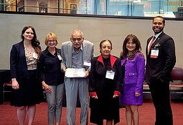 Shawkey and Sanaa Ghobrial, at center, receive the Michigan Community Action Award for Volunteer Service.