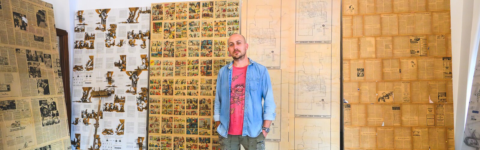 Nick Azzaro with many of his large collages at RAC.