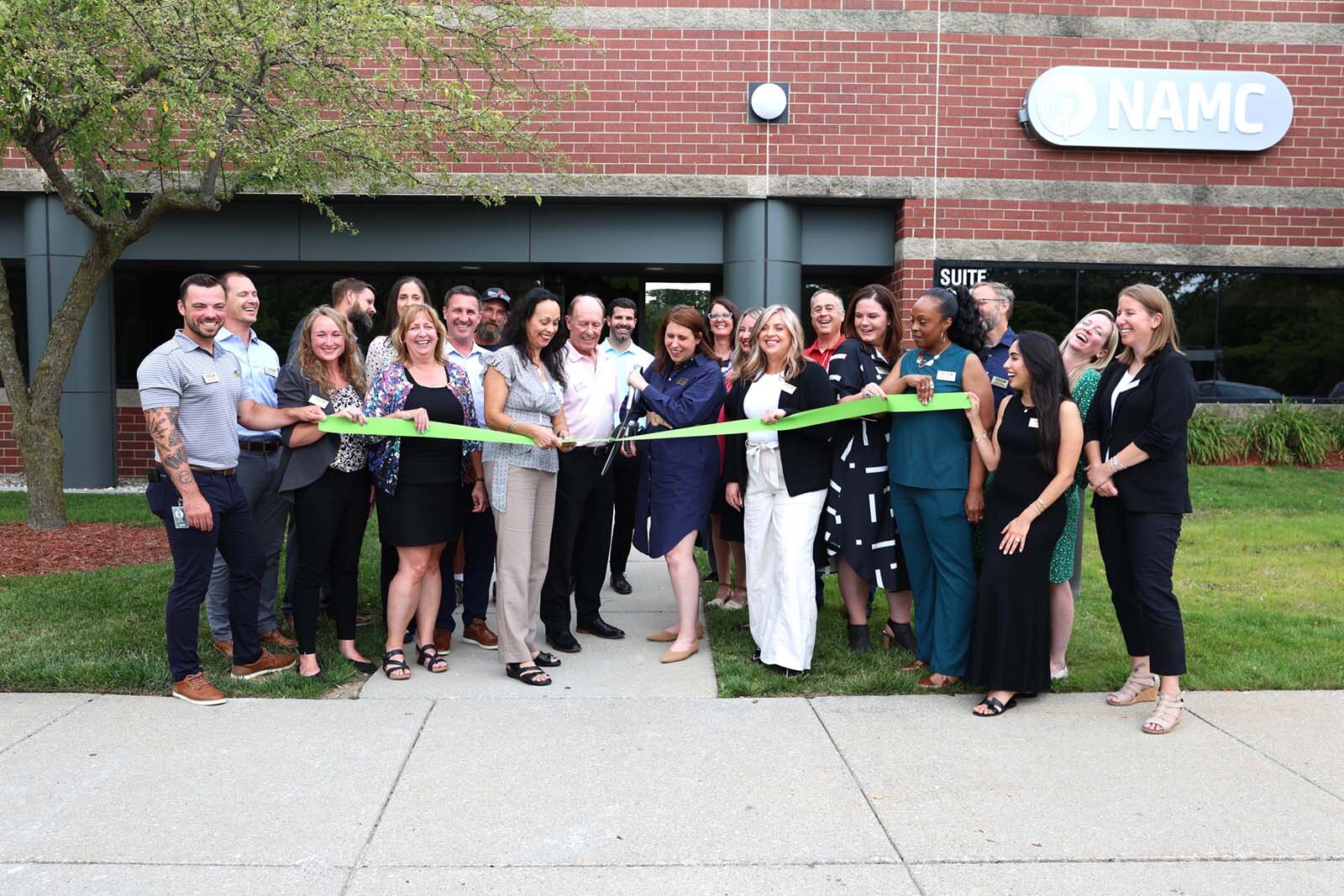 A ribbon cutting for NAMC's new headquarters in Ann Arbor.