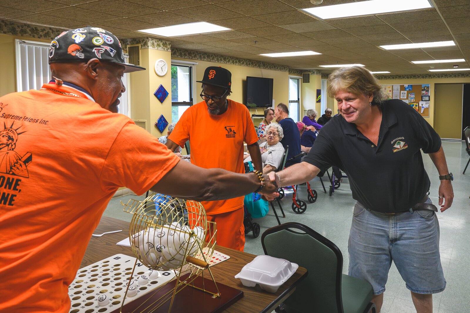 Billy Cole handing out a prize during a bingo game at Chidester Place.