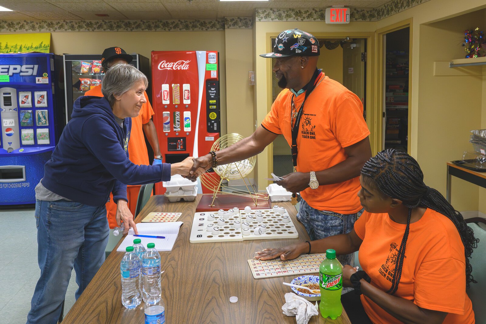 Billy Cole handing out a prize during a bingo game at Chidester Place.