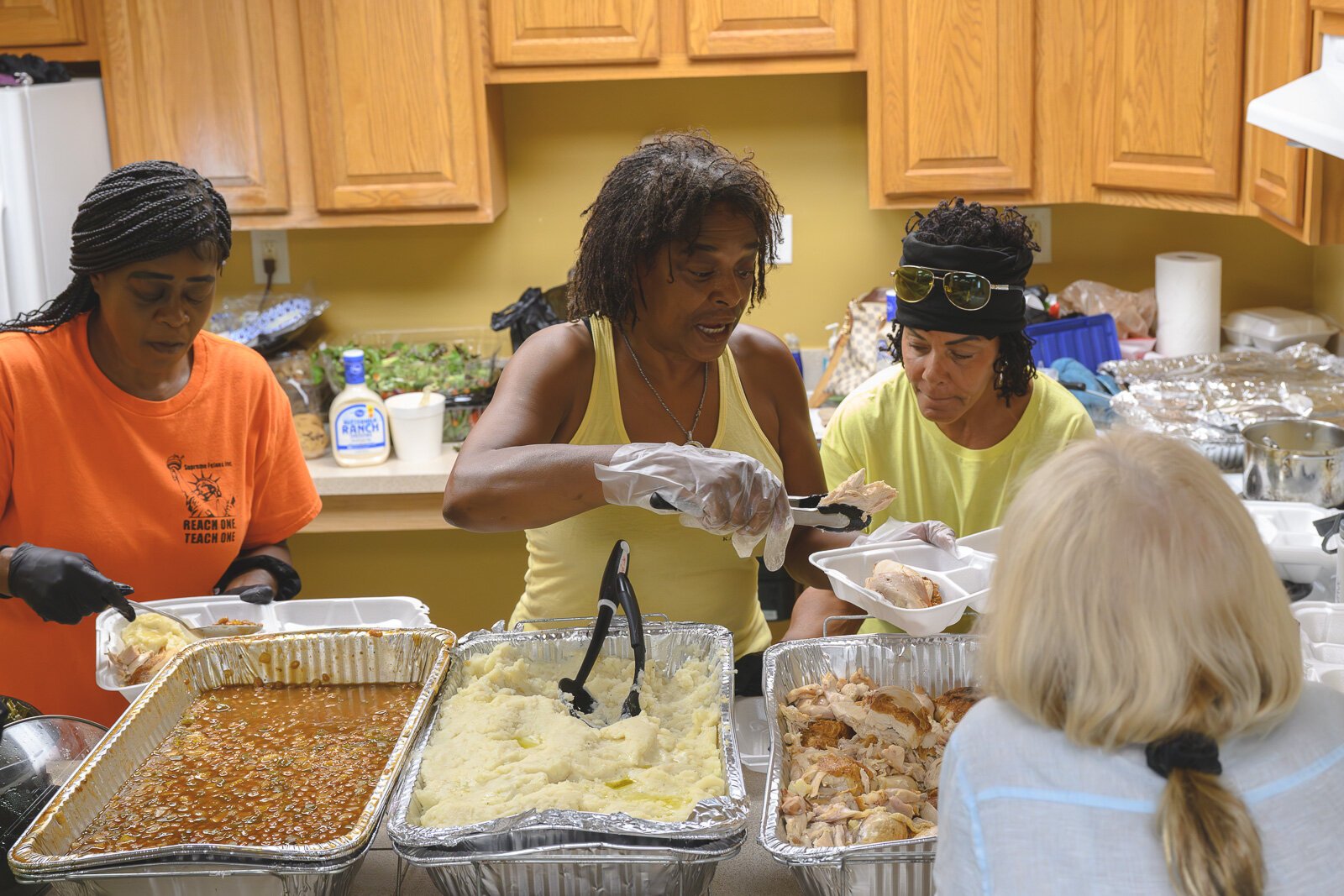 Sonya Townshend, Lisa Barfield, and Bonnie Lawrence serving meals at Chidester Place.