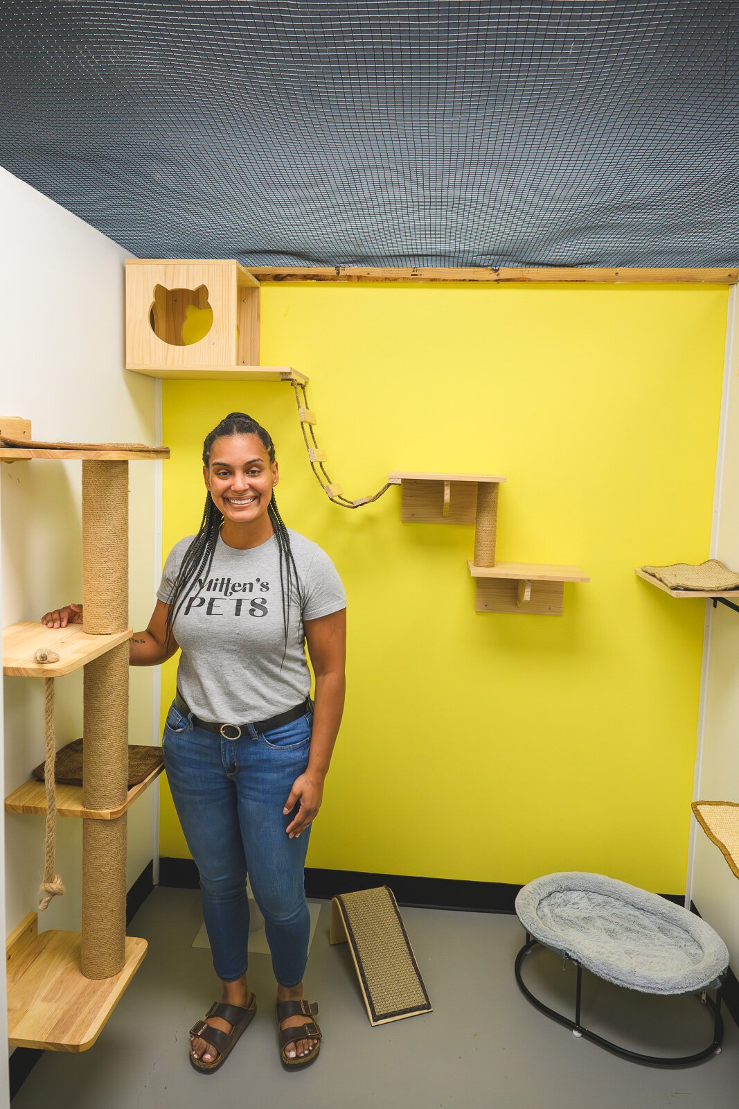 Hannah Moretto in a cat boarding room at Mitten's Pets.