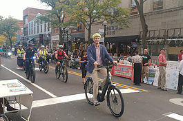 Ann Arbor Mayor Christopher Taylor leads a bike parade at the 2023 Green Fair.