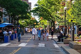 People walk down Main Street in Ann Arbor.