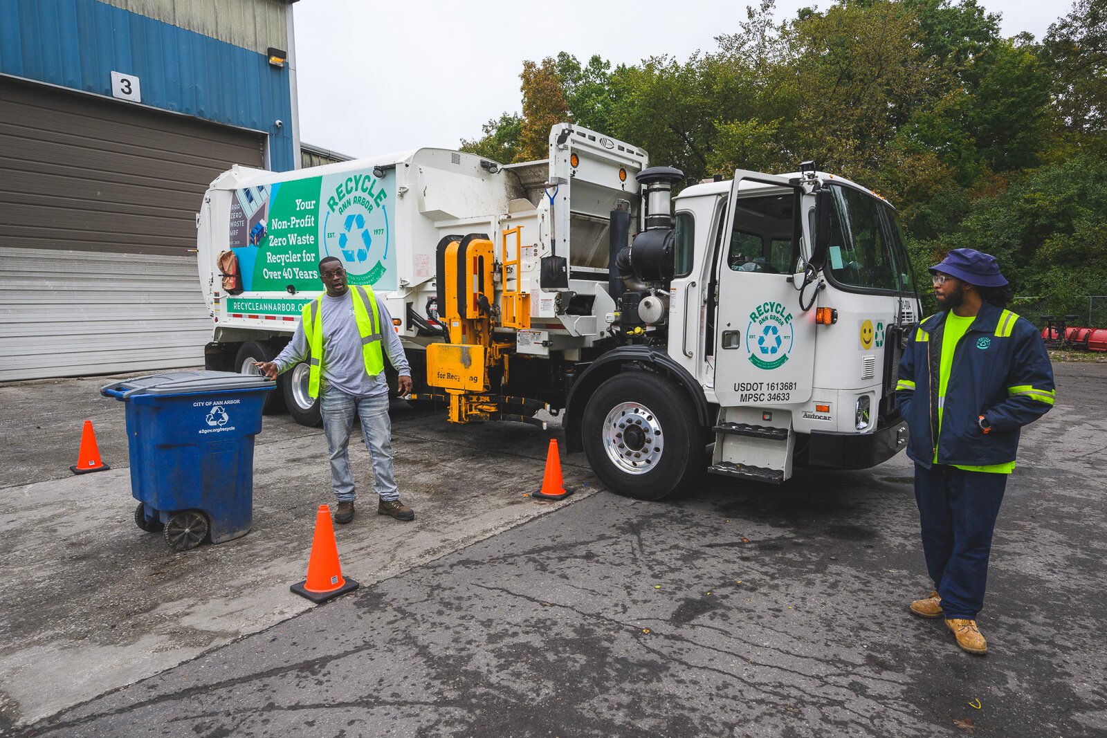 Courtney Franklin and Greg Carter demonstrating a recycling truck at the Ann Arbor's Material Recycling Facility tour.