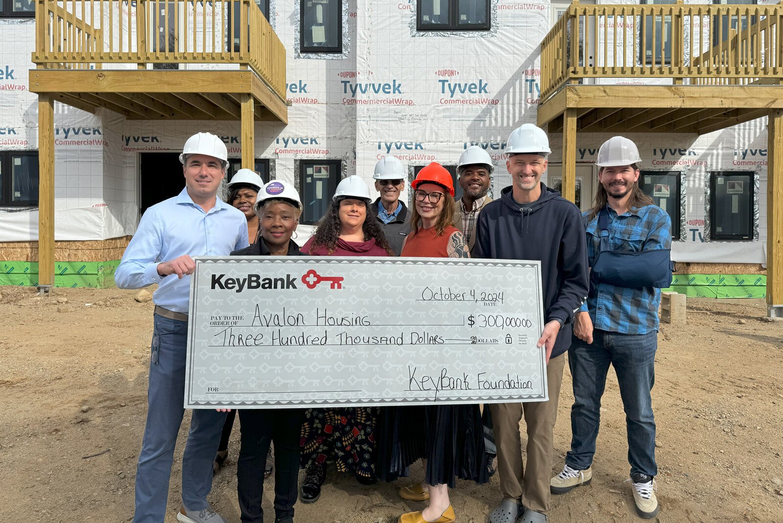 KeyBank and Avalon Housing staff pose with a check for KeyBank's $300,000 grant to Avalon.