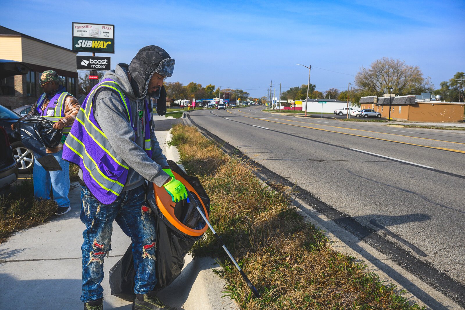 Eric Martin with the SHINE team cleaning on Ecorse Road.