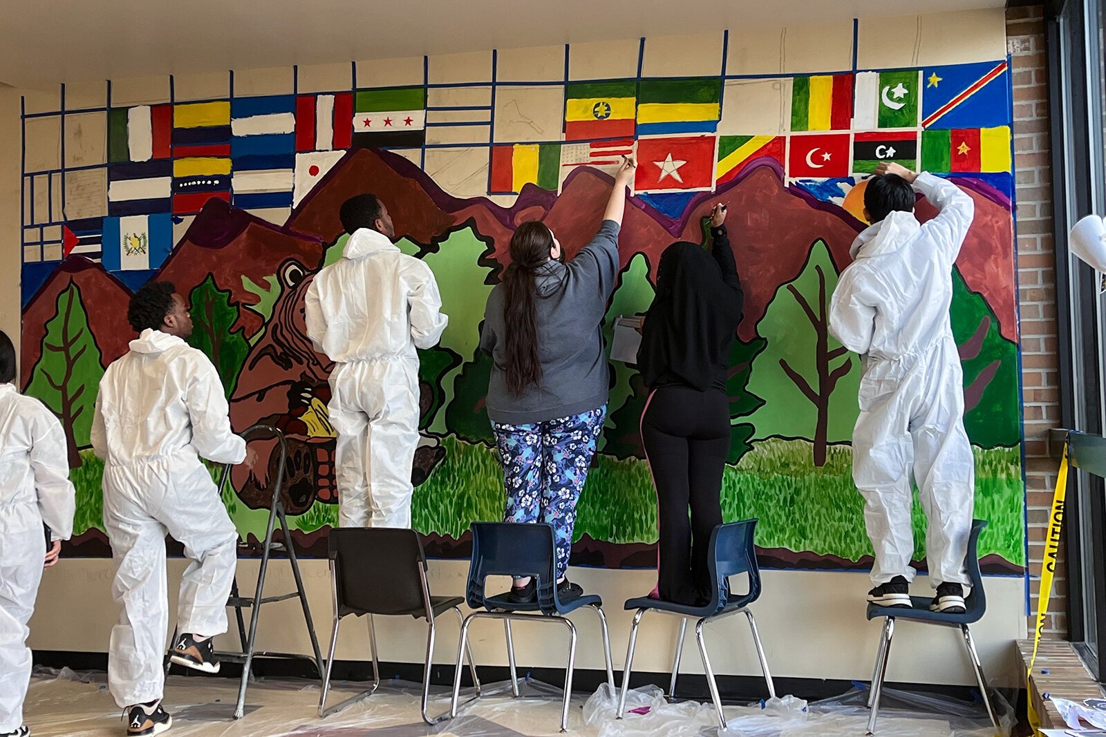 Kids working on a Youth Art Gallery mural.