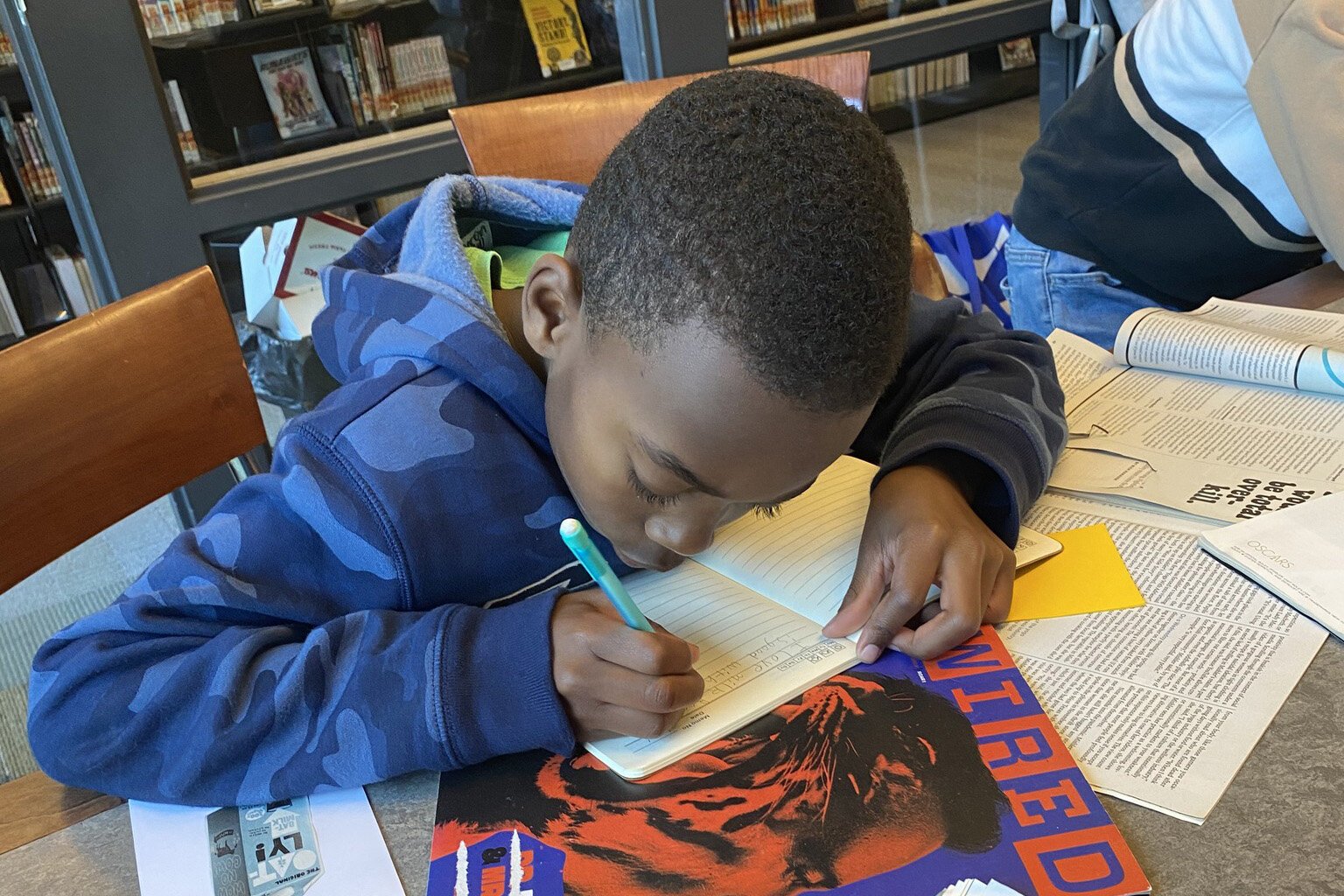 A young person writes at a Dzanc House workshop.