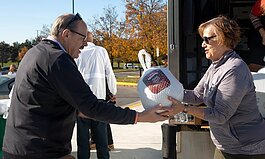 EMU President James Smith and "Thankful For You" event planning committee member Connie Ruhl-Smith at last year's drive-through Thanksgiving meal giveaway.